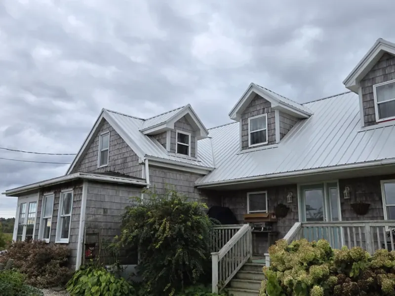 Standing-seam metal roof installed on a multi-dormer home.