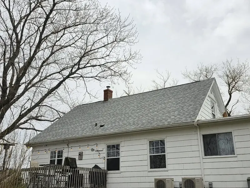 Newly installed asphalt shingle roof on a Cape Cod home.