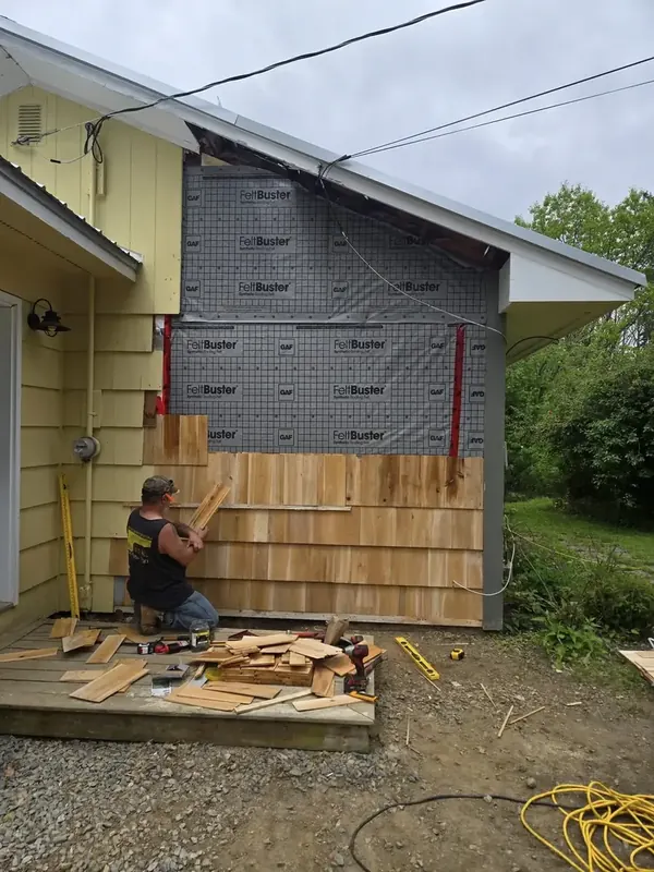 Cedar shingle siding installation in progress on a Hantsport home.